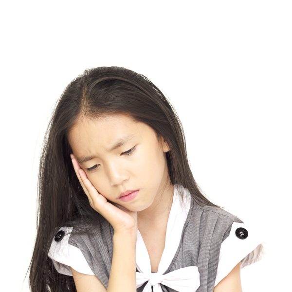 Depressed Asian girl isolated over white background